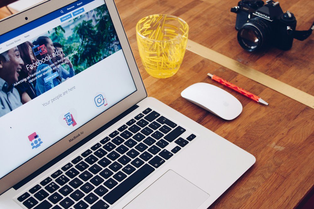 Social media marketing workspace with a laptop and camera
